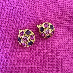Pink and Purple Rhinestones set in yellow tone gold dome. Clip-ons.